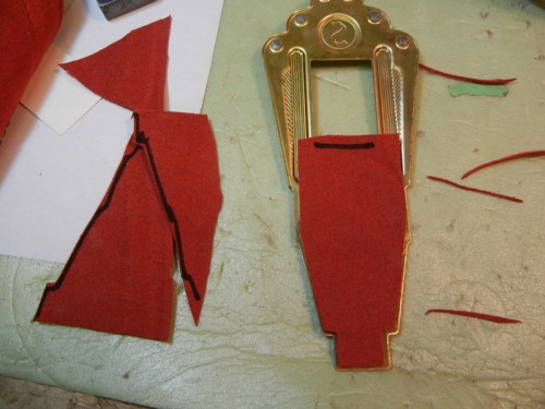 red suede leather piece glued to underside of tailpiece