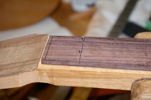 fingerboard tacked to neck prior to gluing