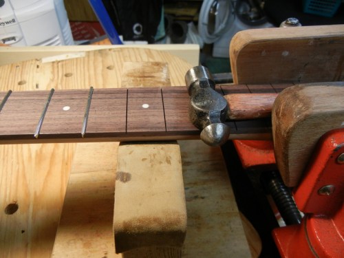 neck clamped in vice and working frets sit on a neck support block