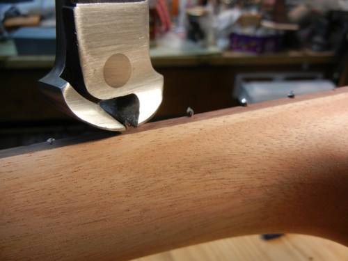 nipping the sharp ends of the frets